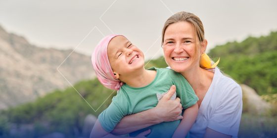 A woman and child outside smiling for a photo